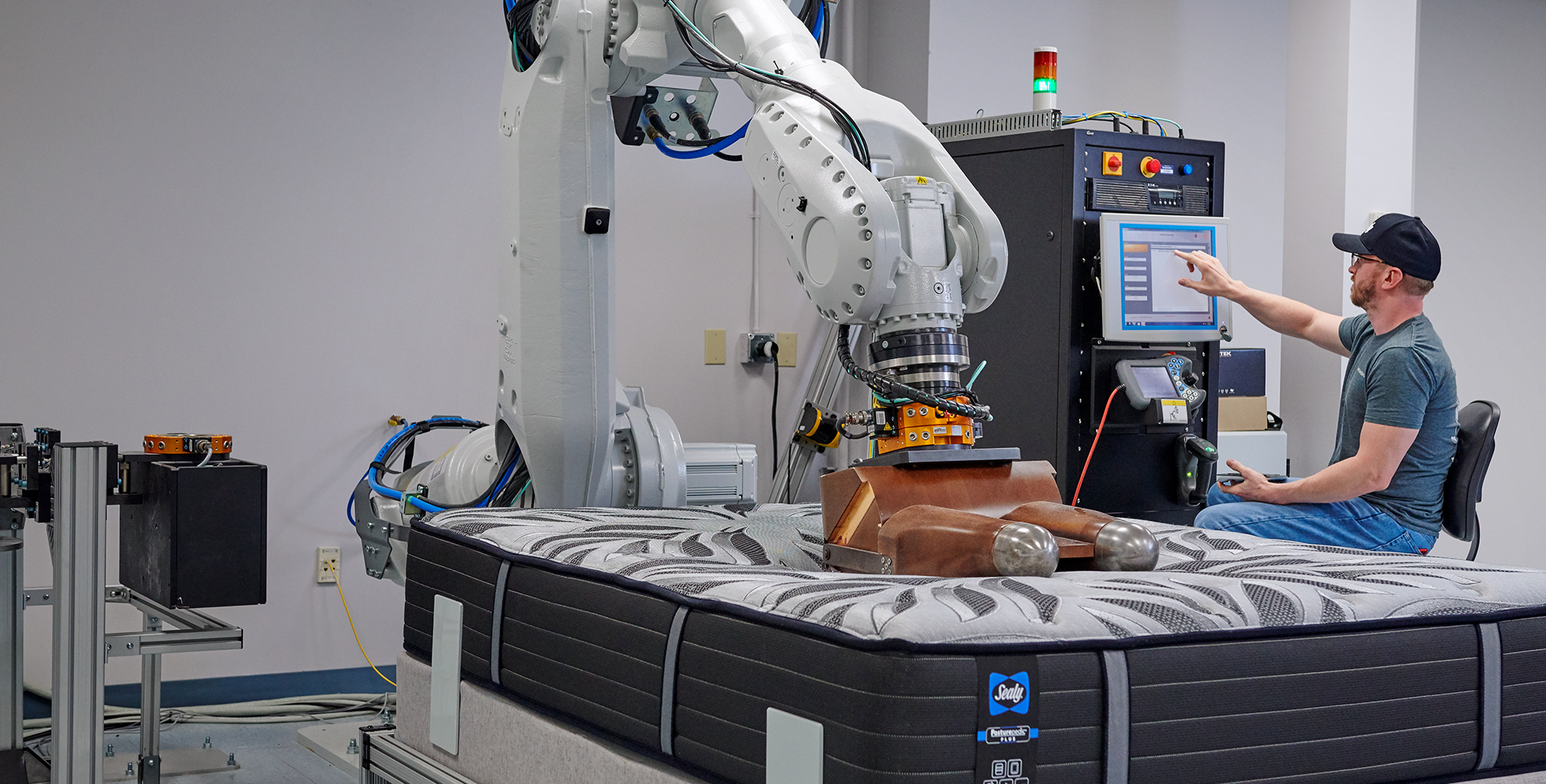 Trinity factory worker testing a Sealy&reg; mattress